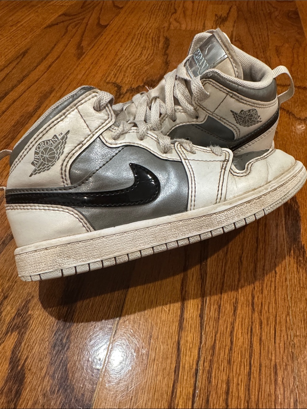 Nike Kids Air Jordan high top Sneakers in White, Silver, and Black